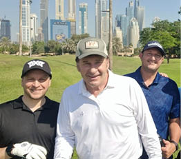 Four men pose for a picture on a golf course, smiling and enjoying their time. AI generated content