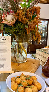 A collage of food images, including various desserts and appetizers, displayed on a table. AI generated content