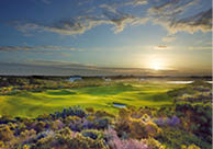 A beautiful sunset over a golf course with a green field and a few houses in the background. AI generated content