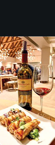 A bottle of wine and a glass of wine are on a table. AI generated content