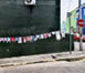 A wall on the side of a building has a row of clothes hanging on it. AI generated content