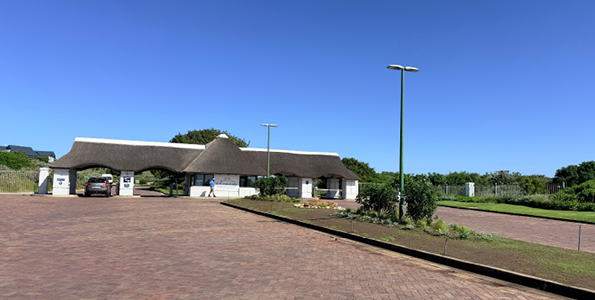 A parking lot with a brick surface and a white building in the background. AI generated content