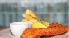 A plate of food with a fish dish and fries. AI generated content